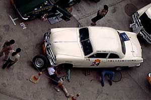 Americans John Jung and Andy Vann work on their 1950
Ford Club coupe.