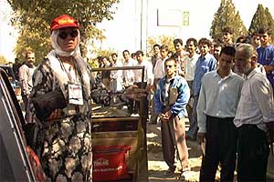 Women drivers such as Linda Dowell draw gawking
crowds even when covered.